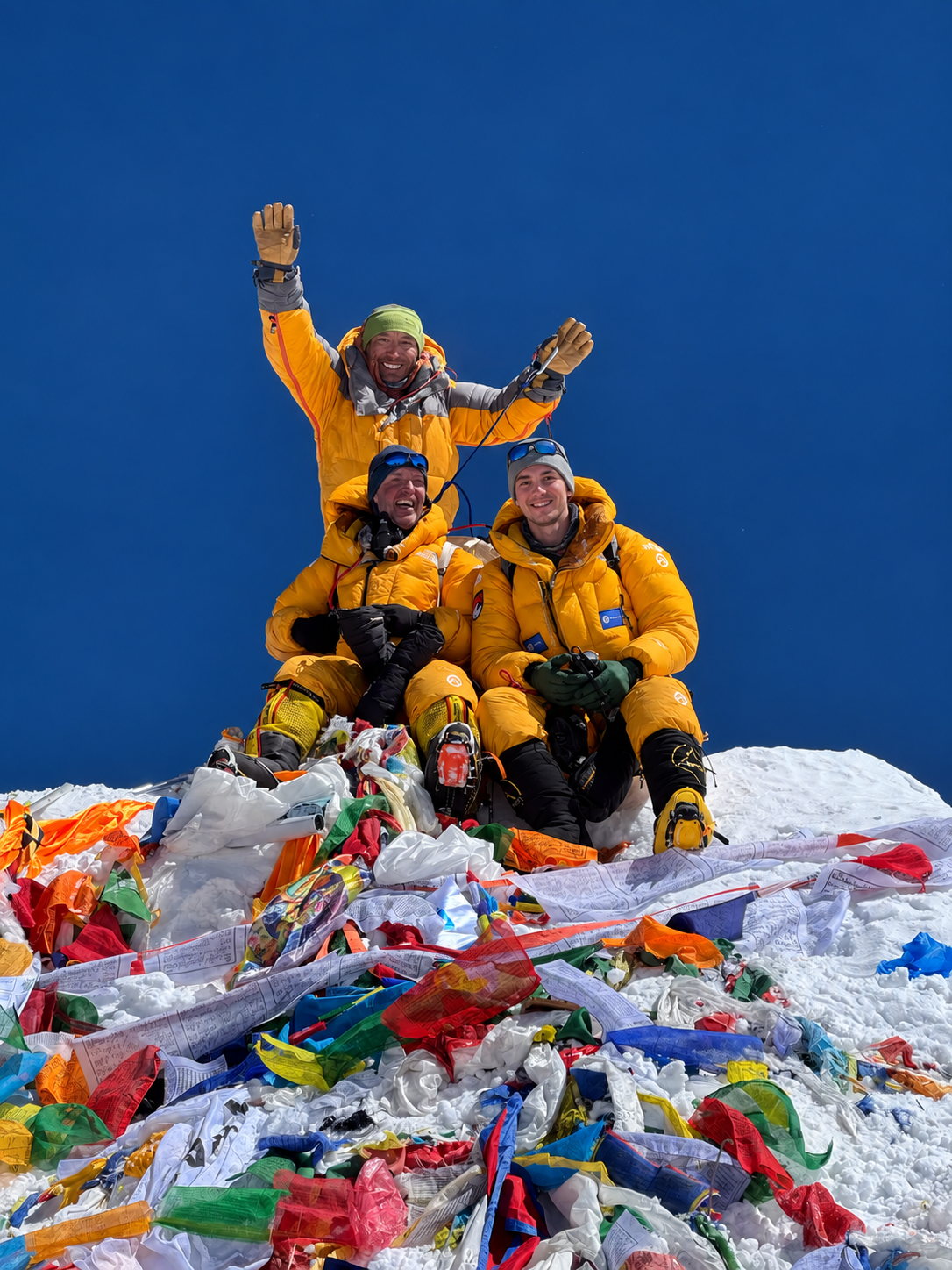 Artsiom celebrating on the summit of Everest, seated at the front right