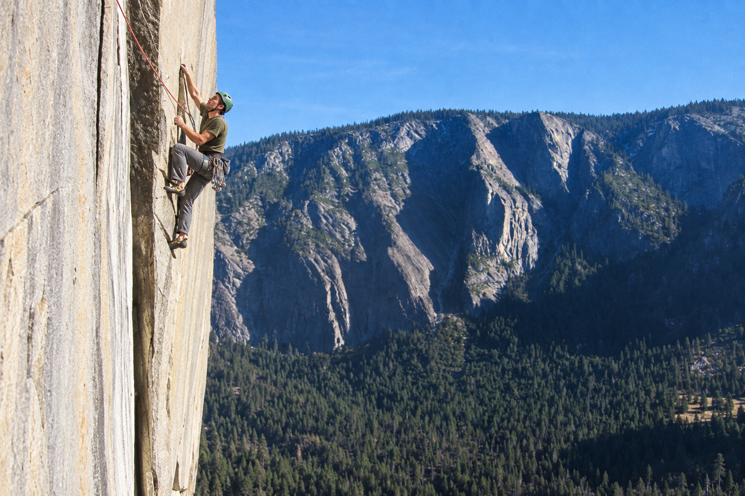 Artsiom climbing a granite wall above Yosemite Valley